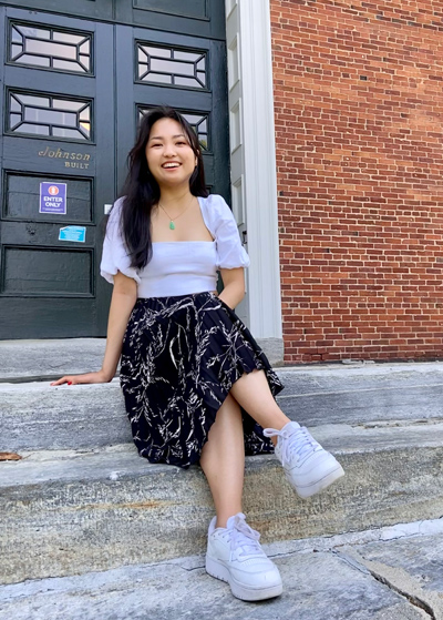 Sabrina Lin sits on the steps of Johnson Chapel
