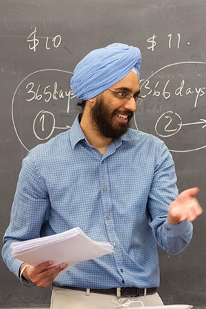 Singh in front of a blackboard