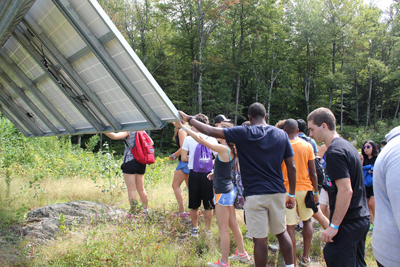 Students touching a solar panel