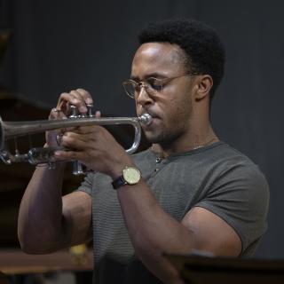 Young trumpet player, plays with closed eyes