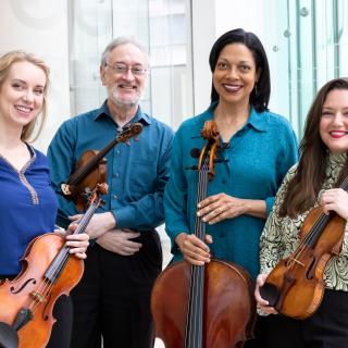 Juilliard String Quartet players holding instruments, smiling credit-Erin-Baiano