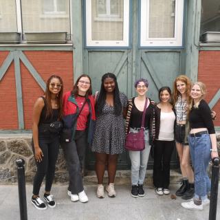 APA students standing in front of the Artist workshops across the street from APA's Paris office.