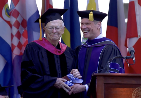 John Kirkpatrick stands with President Elliott on stage at Amherst College commencement