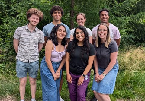 lab group stands in front of trees