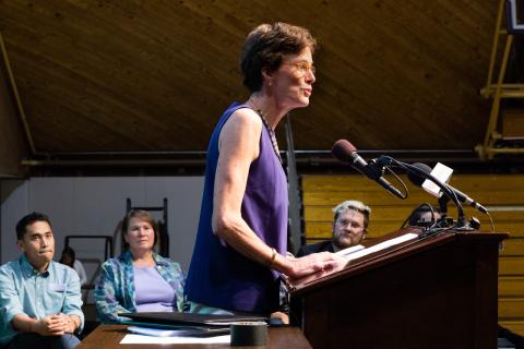 Katie Fretwell speaking at a podium at Amherst College Orientation 2017