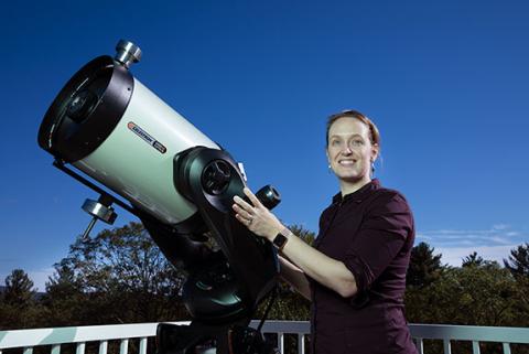 Kate Follette using a telescope on the Amherst College campus