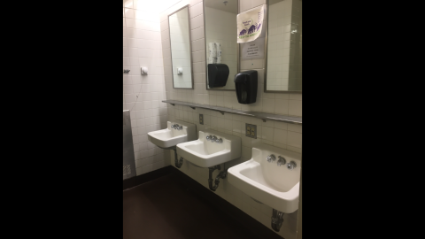 three sinks and three mirrors in a Moore bathroom