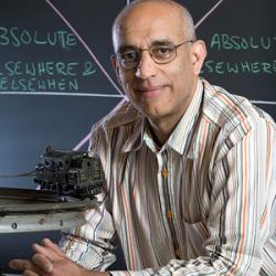 Jagu smiling in a collared shirt with a microscope 